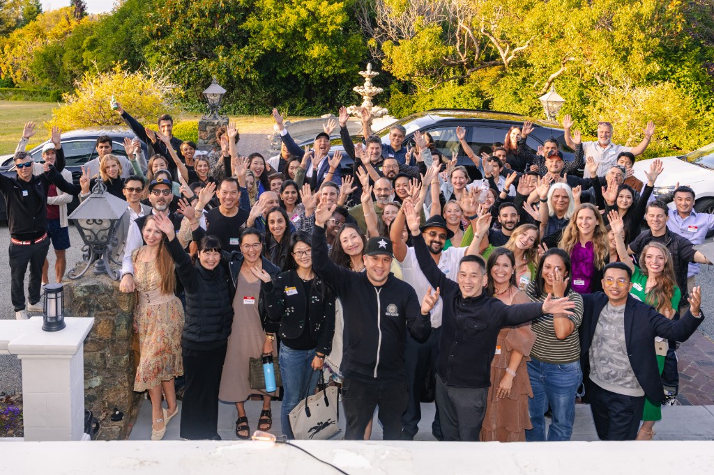 Vitalium community members waving at an outdoor gathering